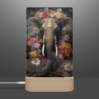 Lampa slon obklopený květinami a listy